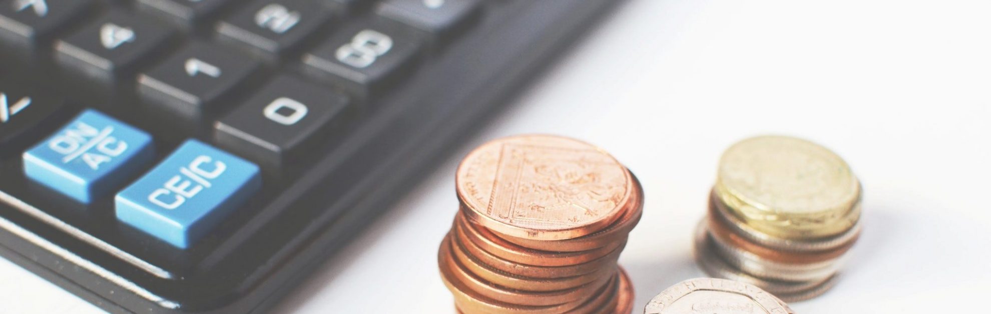 Calculator and a pile of coins