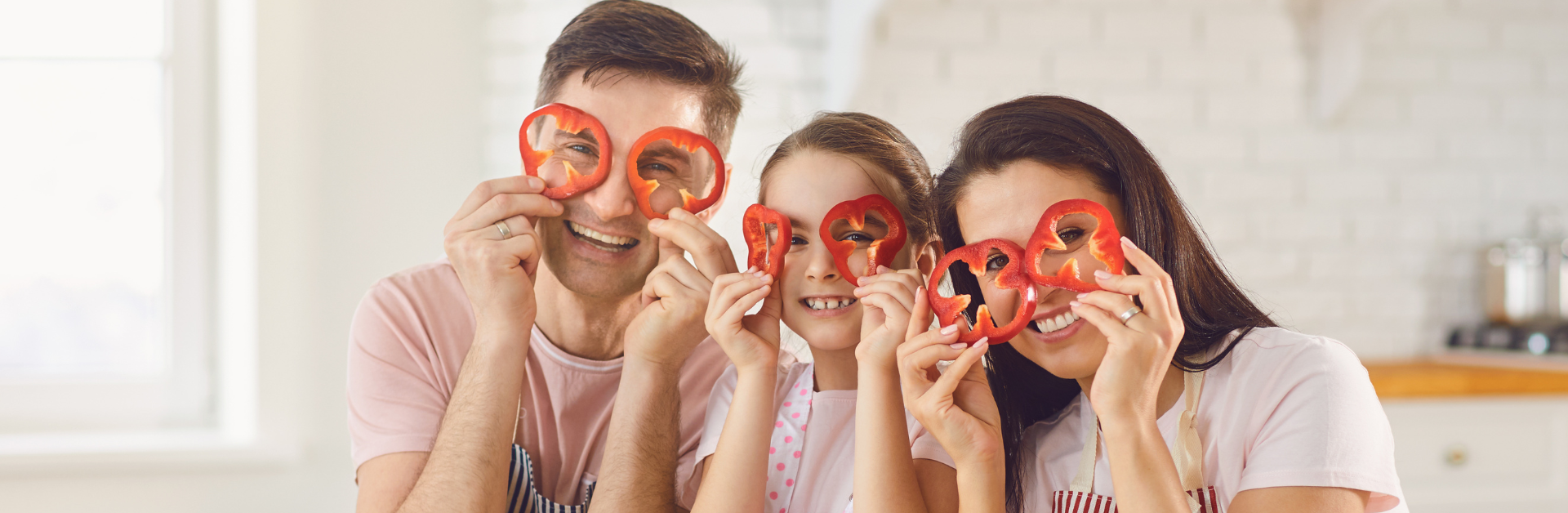 happy family playing with red peppers
