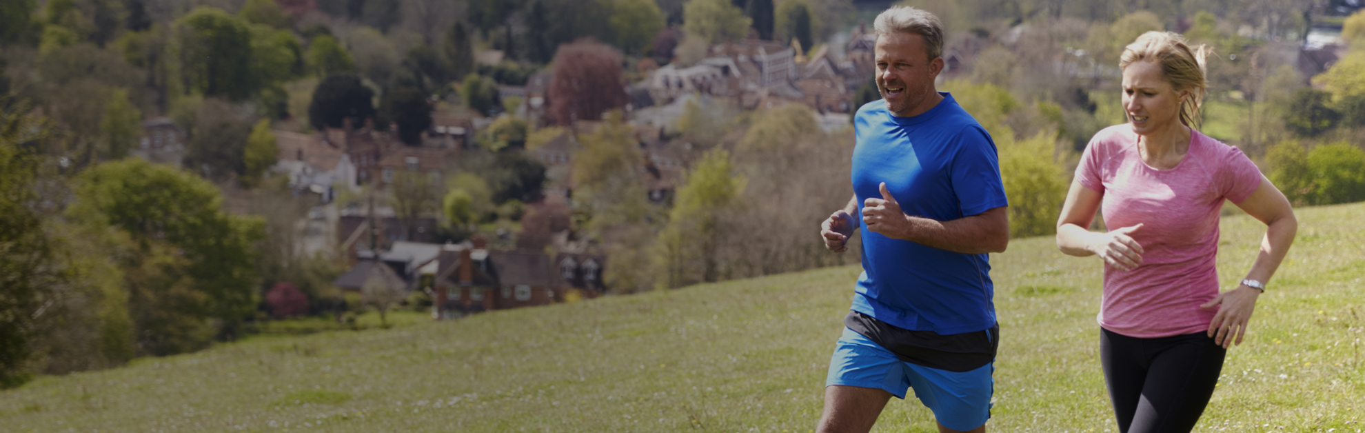 Two people running in the countryside